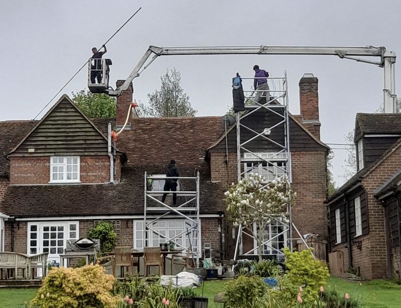 The Moss Cleaners using cherry picker and scaffolding to clean roof safely and professionally in Hartley Wintney, Hampshire